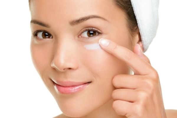 Skin care woman putting face cream